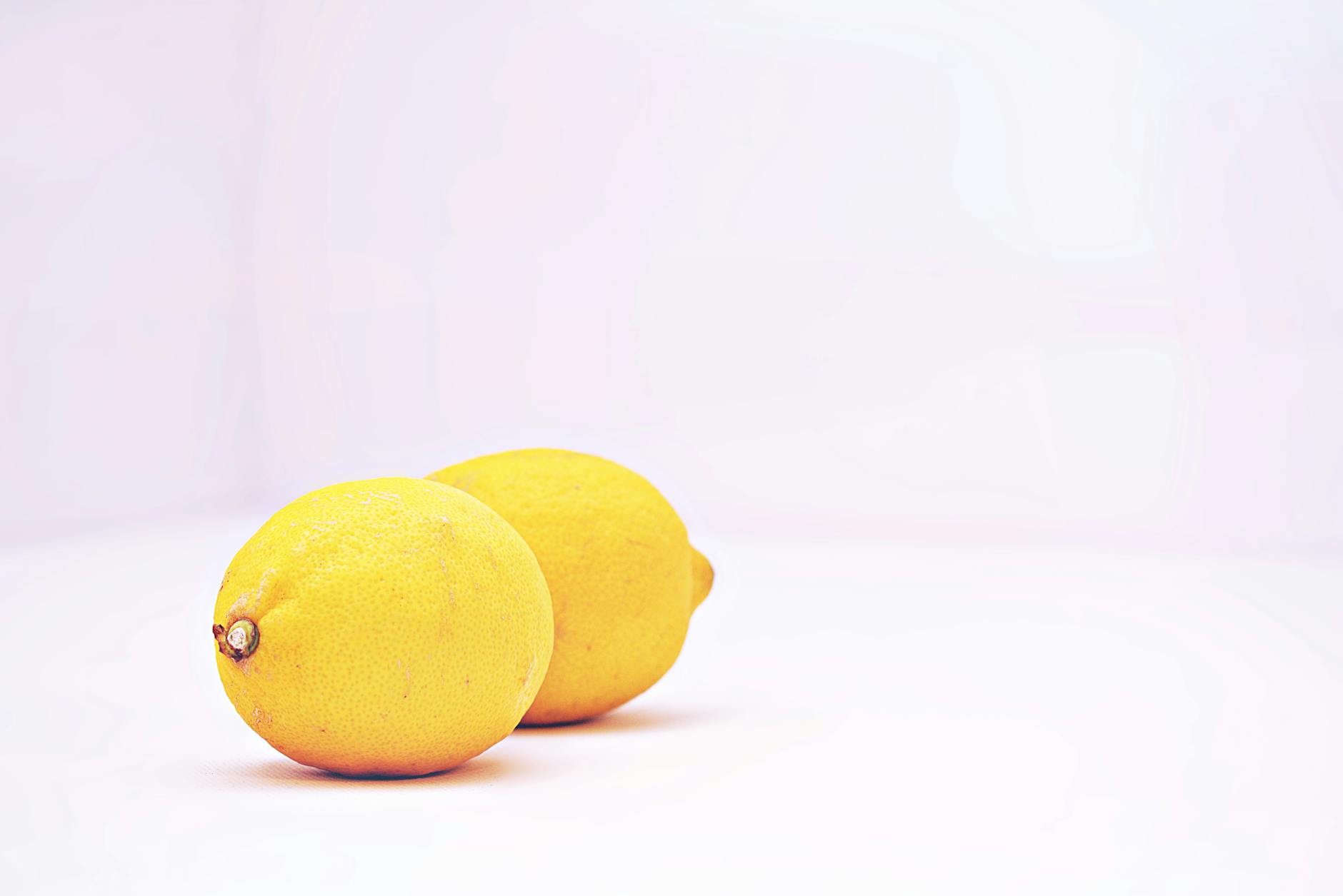 Two vibrant lemons on a white background, representing fresh approaches to intimacy