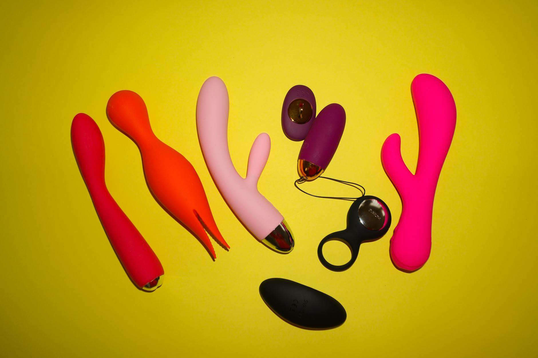 Teal lemon clitoral vibrator on white silk fabric