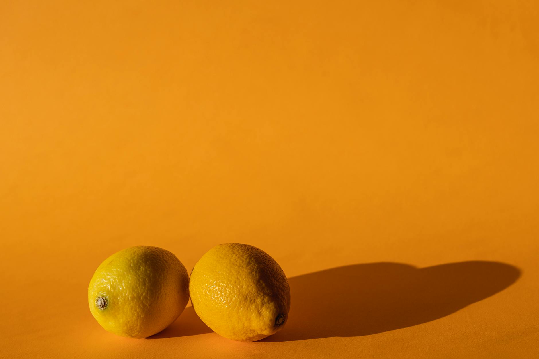 Ripe lemons on a bright yellow background in natural light